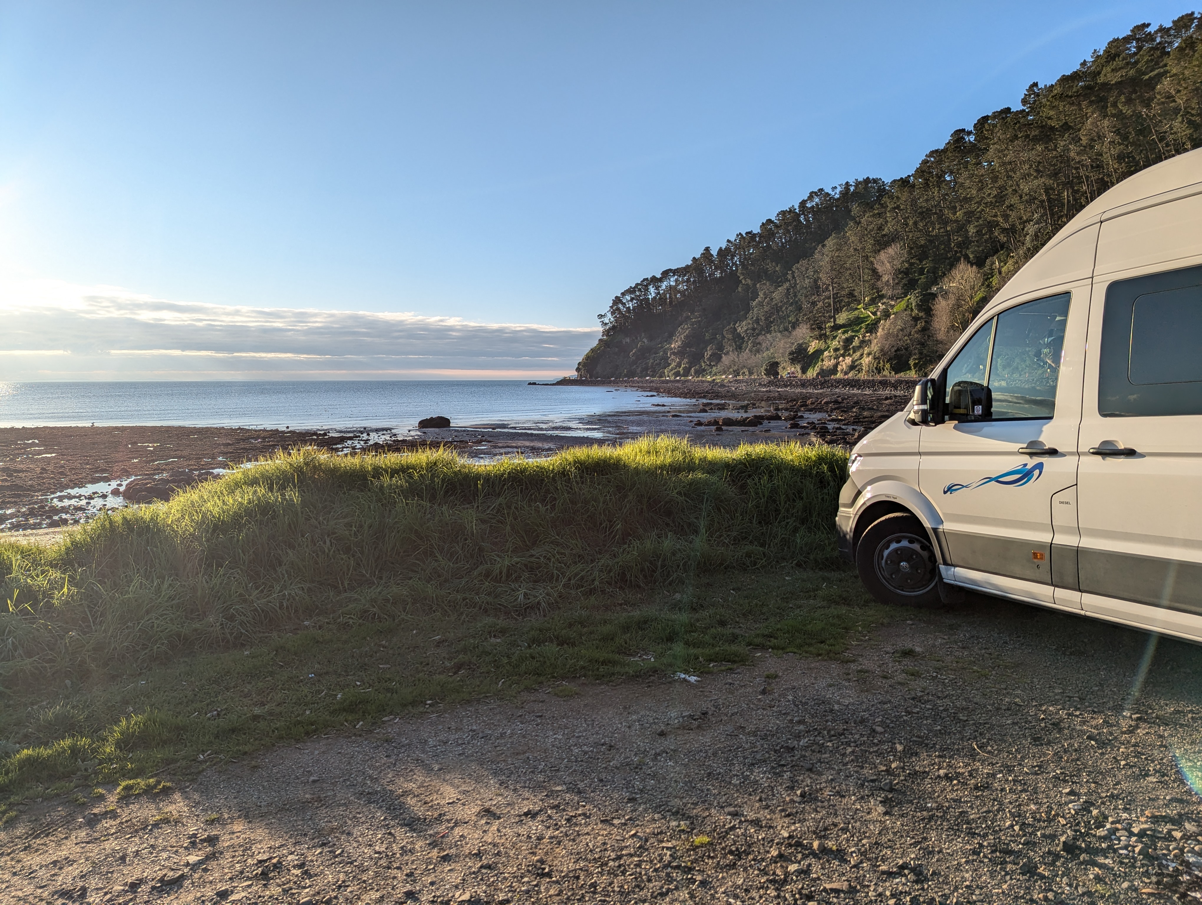 Campervan parked at Tararu Beach Resere, North Island, New Zealand